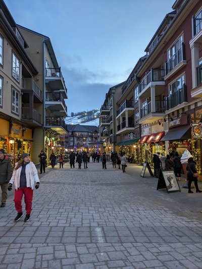 Blue Mountain Village — Evening shopping street with visitors and illuminated storefronts
